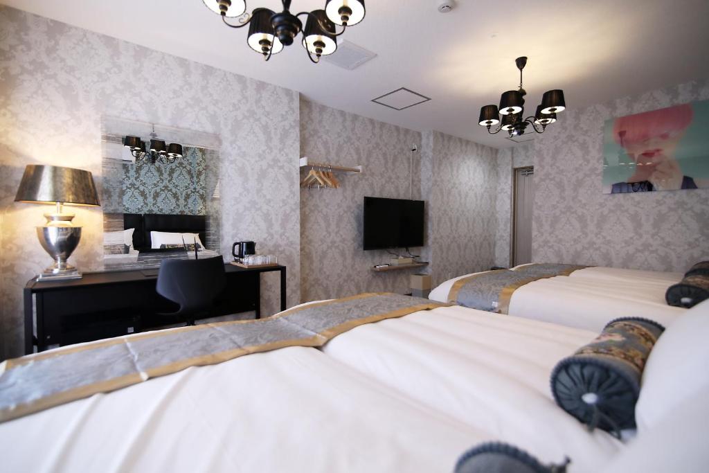 Postel nebo postele na pokoji v ubytování SHINJUKU GLOBAL HOTEL