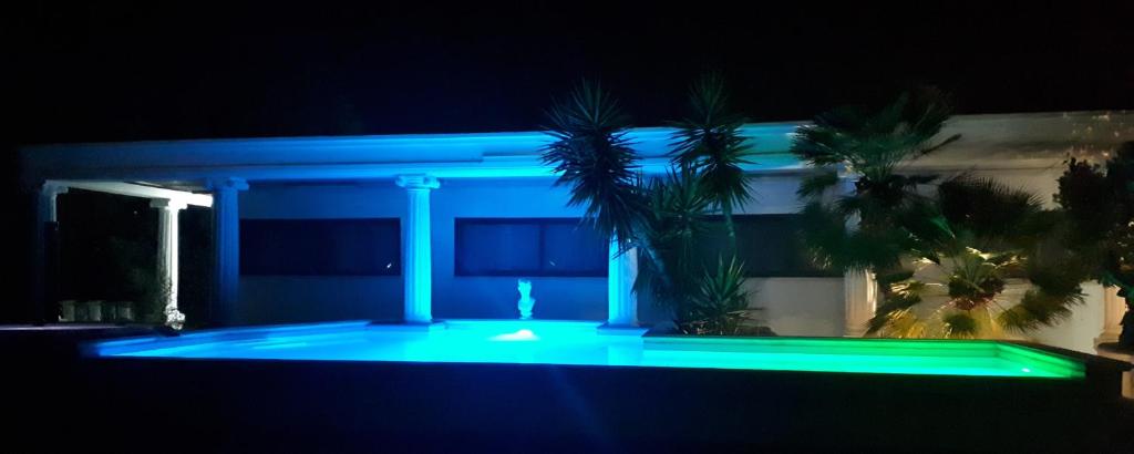 a house with a blue light on it at night at Hotel Chopin in Fiumicino