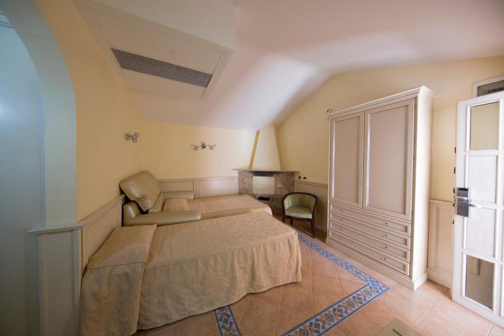 Postel nebo postele na pokoji v ubytování Mancini Park Hotel