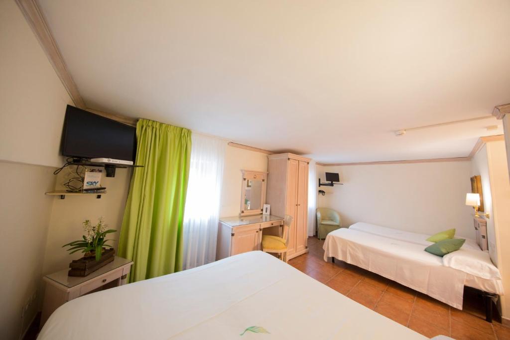 Postel nebo postele na pokoji v ubytování Mancini Park Hotel