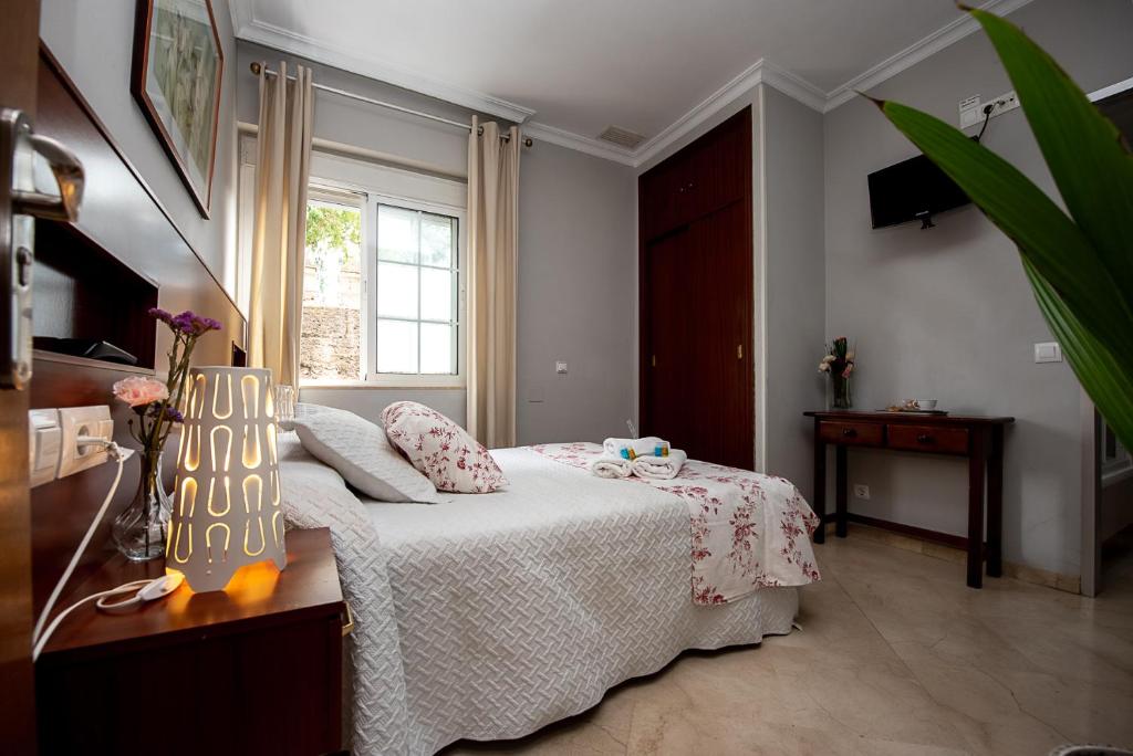 Postel nebo postele na pokoji v ubytování Hostal La Muralla