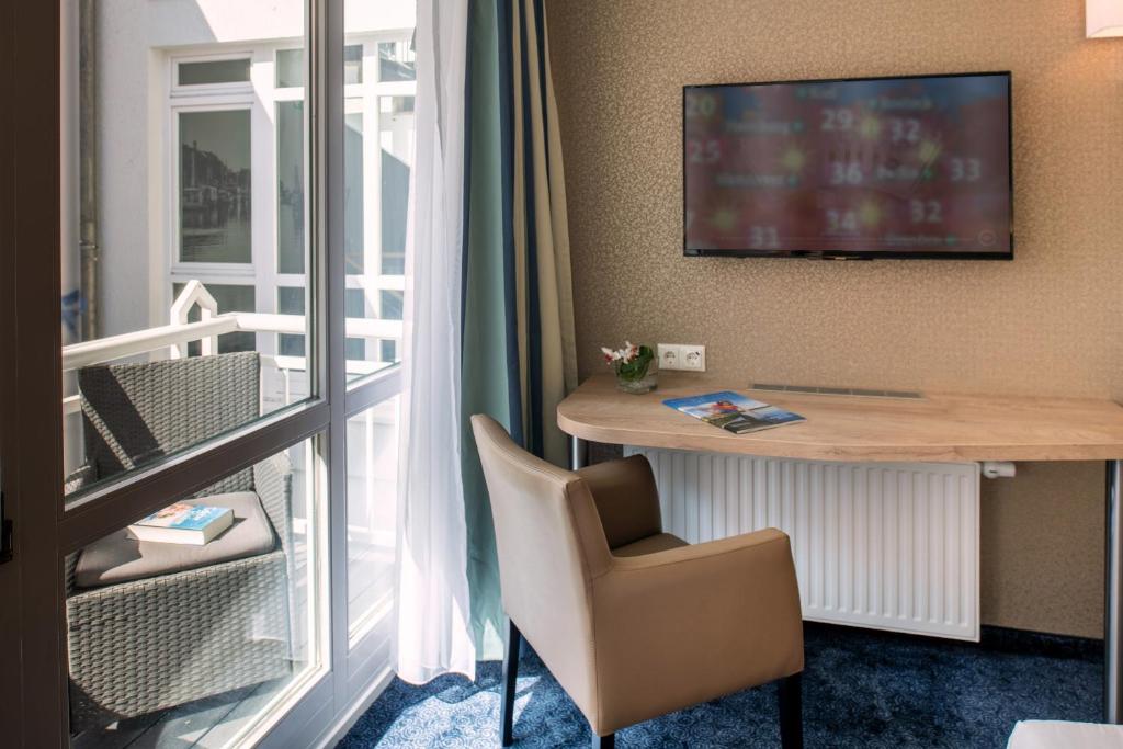 TV a/nebo společenská místnost v ubytování Pension StromInn