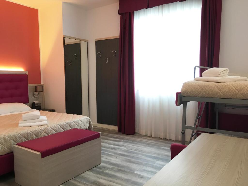 Postel nebo postele na pokoji v ubytování Alma Living Hotel- Al Girarrosto