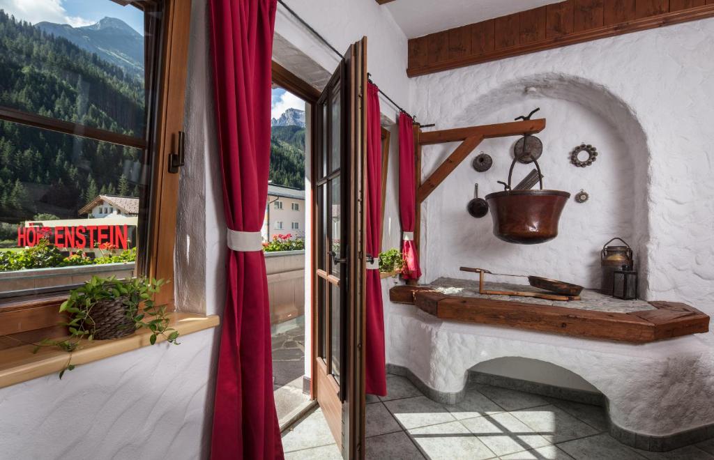 a bathroom with a stone sink and a window at Hotel Höhlenstein in Tux
