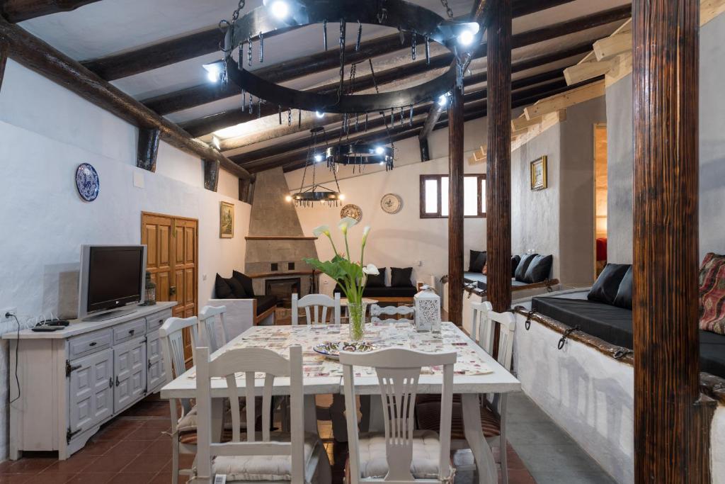 - une salle à manger avec une table, des chaises et un canapé dans l'établissement Casa el Refugio de Arucas, à Arucas
