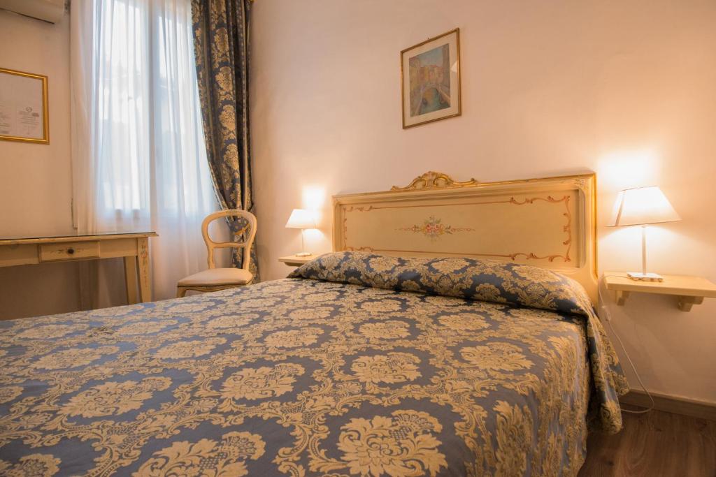 Postel nebo postele na pokoji v ubytování Albergo Casa Peron