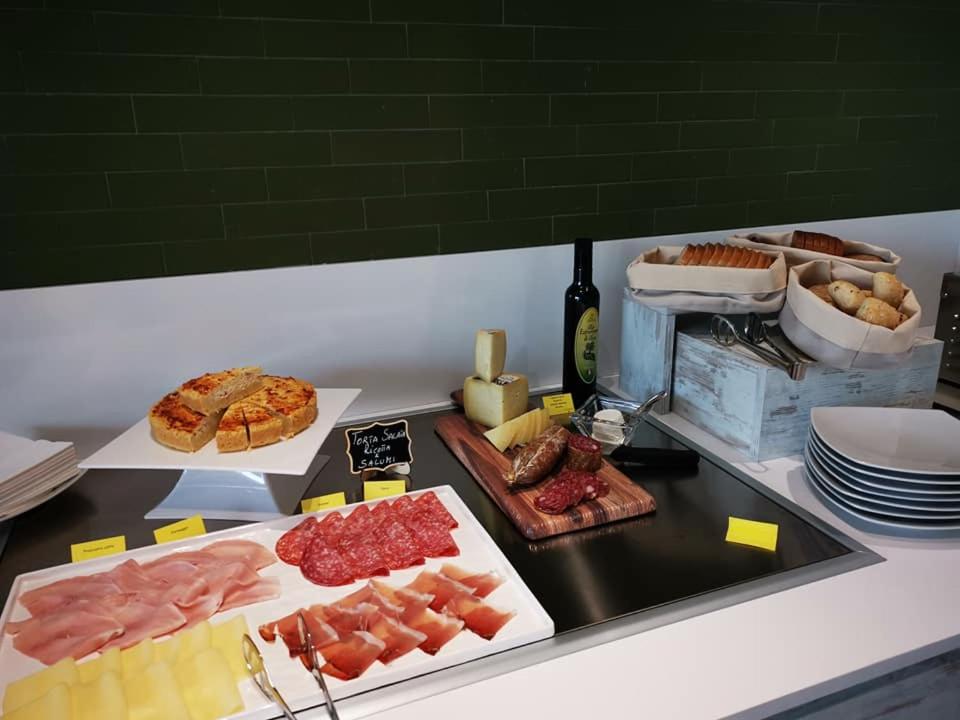 a counter with different types of meats and cheese at YOUMAMI Suite Hotel Wellness&Spa in Giulianova