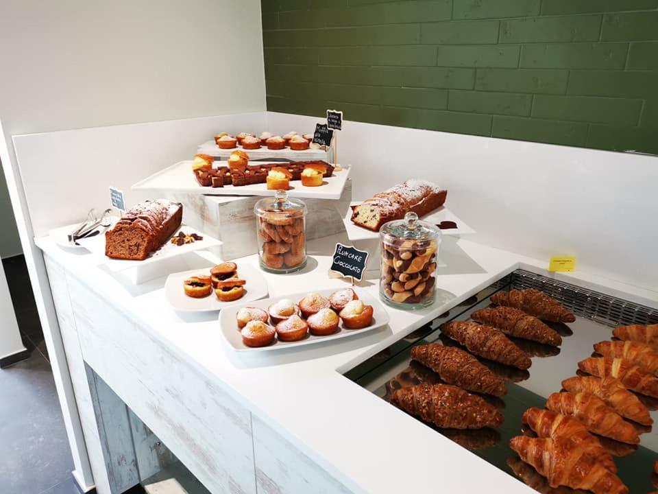 a buffet with different types of pastries and desserts at YOUMAMI Suite Hotel Wellness&Spa in Giulianova