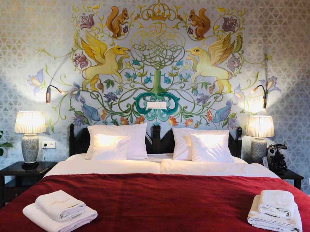 En eller flere senge i et værelse på Hotel Ester