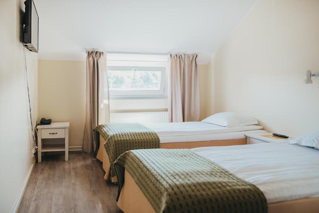 Postel nebo postele na pokoji v ubytování Economy Hotel