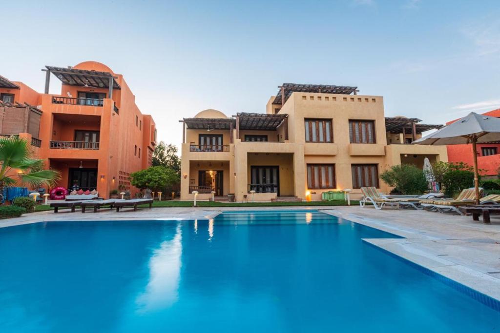 a large swimming pool in front of some buildings at El Gouna 2 bedrooms apartment South Marina Ground Floor in Hurghada