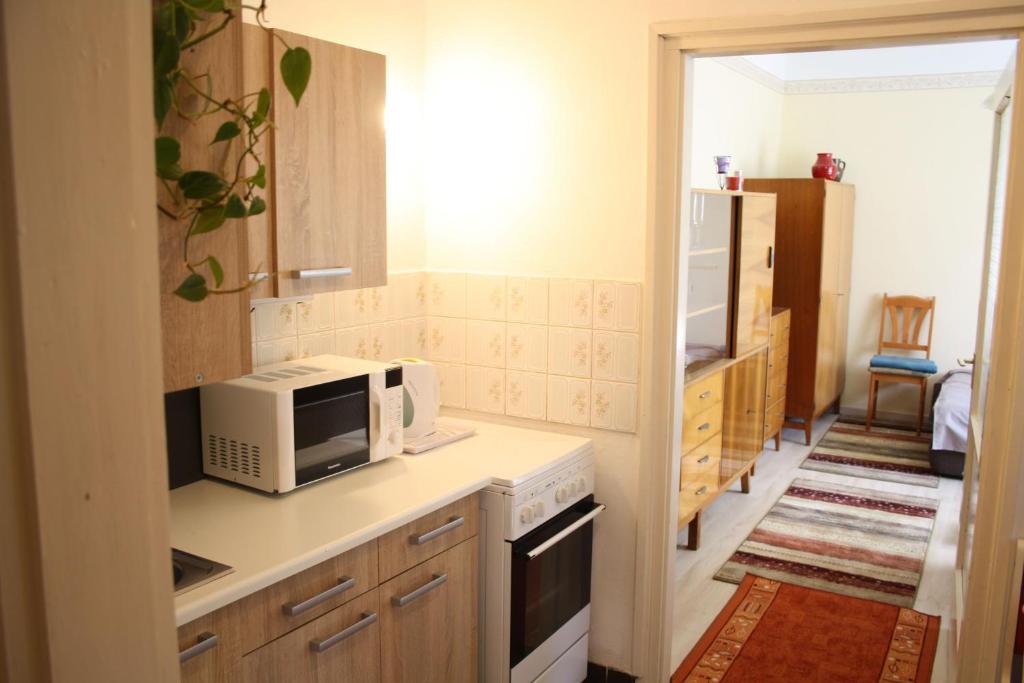 a kitchen with a microwave and a stove top oven at Casa Mamma in Budapest