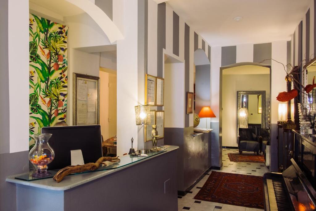 a hallway with a reception desk in a house at Hotel Colombo Genova in Genoa