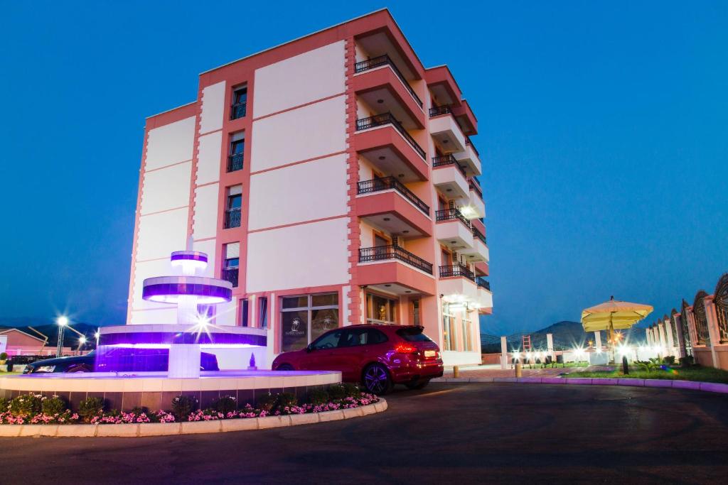 a building with a car parked in front of it at Hotel Oasis in Podgorica