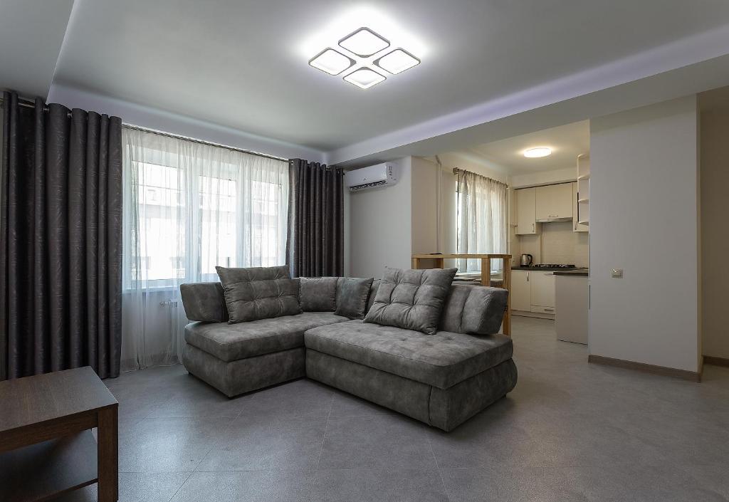 a living room with a couch and a kitchen at Apartment on Peremohy Ave 20 in Kyiv