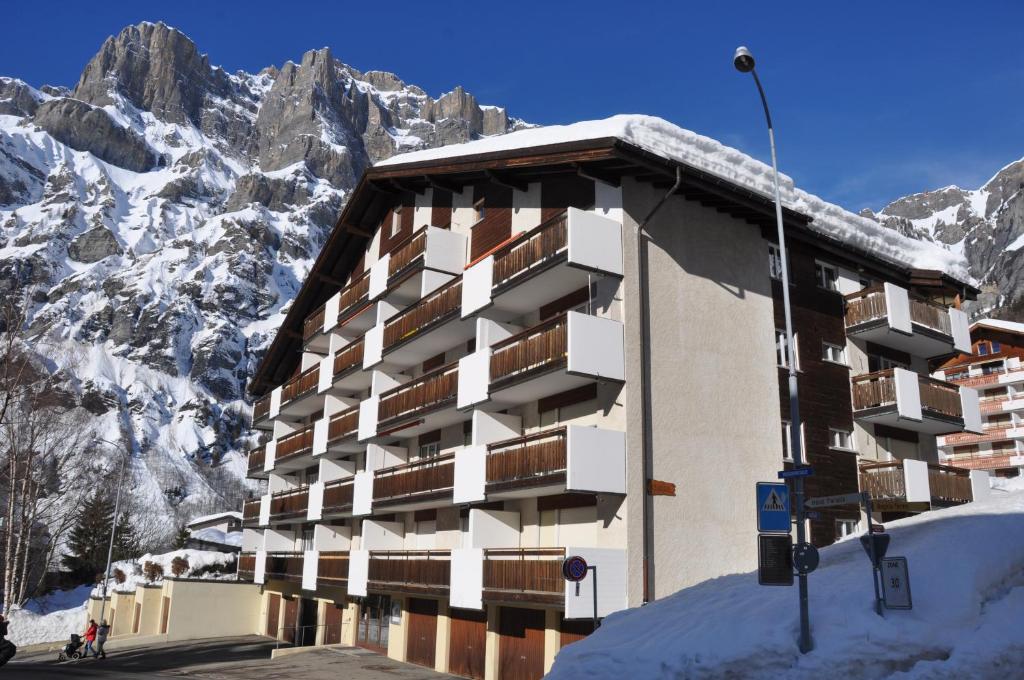 a building in the mountains with snow on it at GOLIATH in Leukerbad