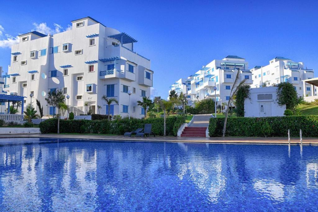 a view of two apartment buildings and a swimming pool at Smir Park in Tetouan