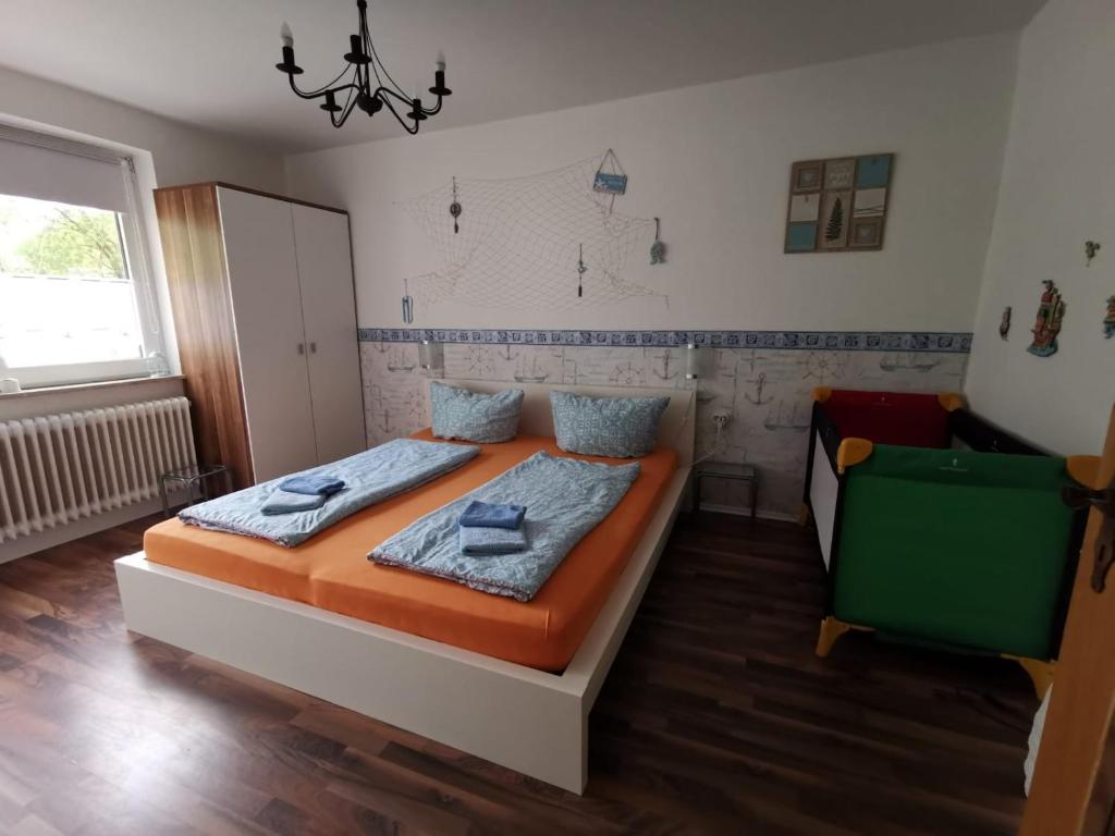 a bedroom with a bed and a chair in it at Ferienwohnung Wattenmeer mit E-Bike Verleih in Wilhelmshaven