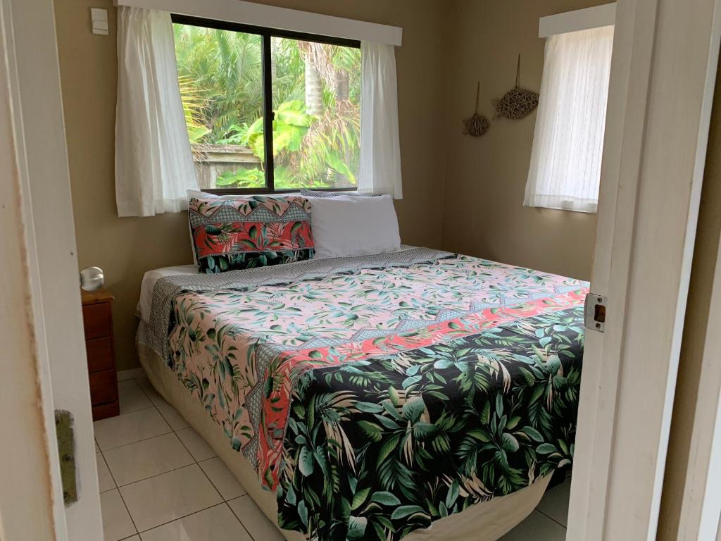 a bedroom with a bed and a window at Manea on Muri in Rarotonga