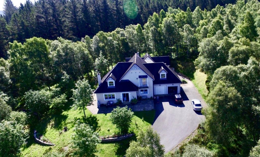 an aerial view of a house in the middle of a forest at The Grey Hen in Inverness