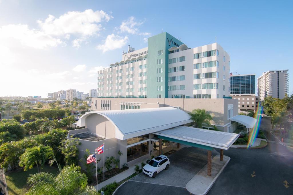 a building with a car parked at a gas station at Verdanza Hotel in San Juan