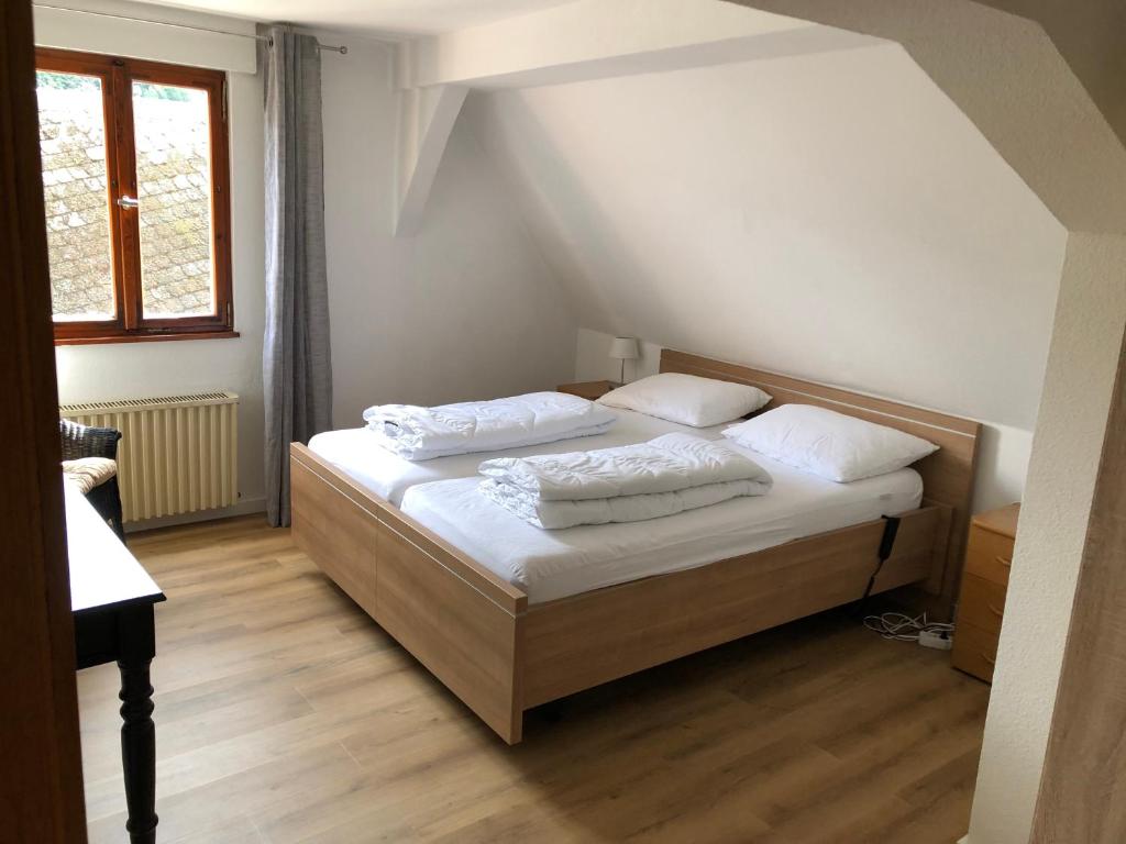 a bedroom with a bed with two pillows on it at vakantiehuismoezel in Sankt Aldegund
