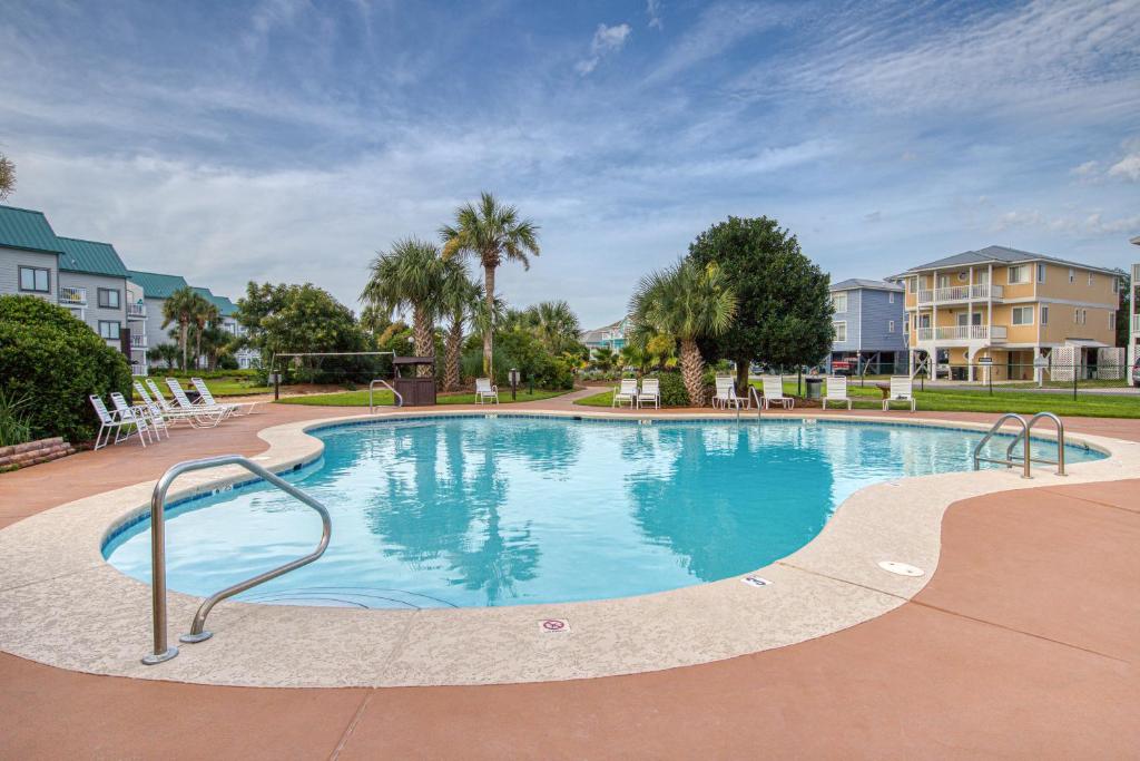 a large swimming pool with chairs in a resort at Plantation West Resort II in Gulf Shores
