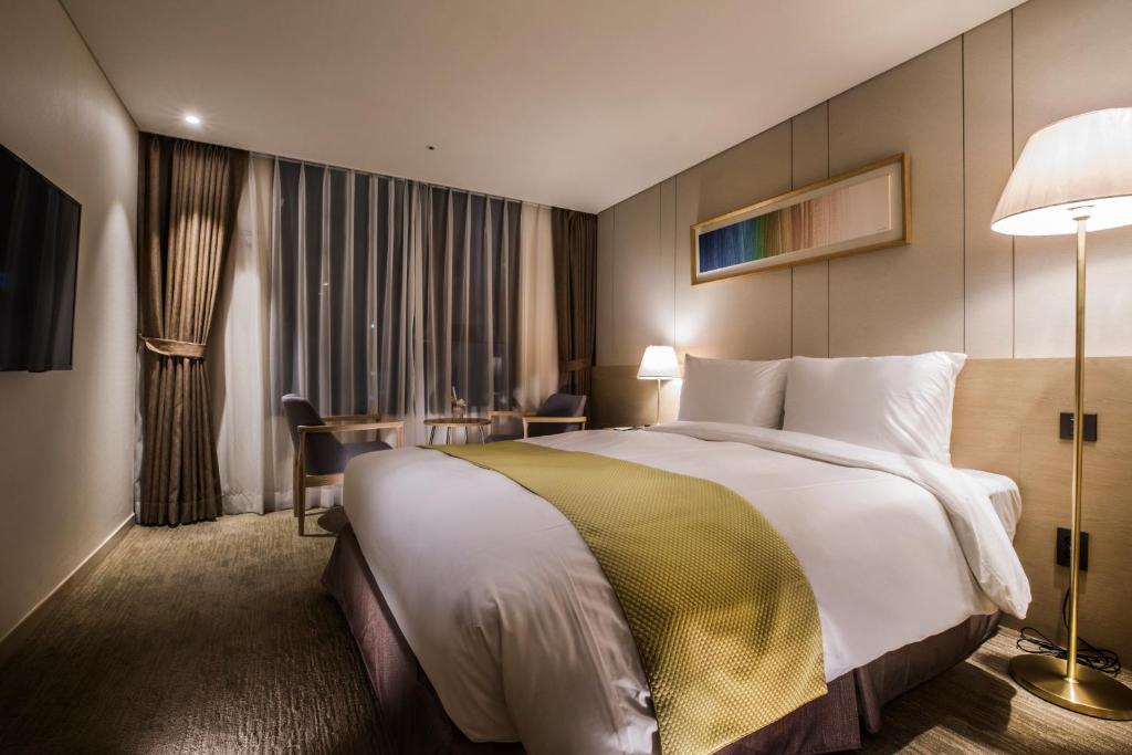 Postel nebo postele na pokoji v ubytování Hotel Winstory
