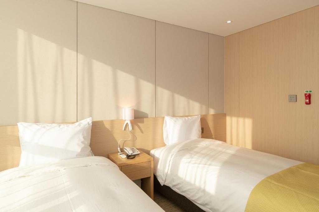 Postel nebo postele na pokoji v ubytování Hotel Winstory