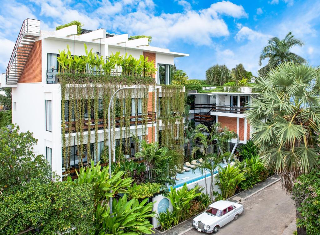 an apartment building with a lot of plants at Viroth's Villa in Siem Reap