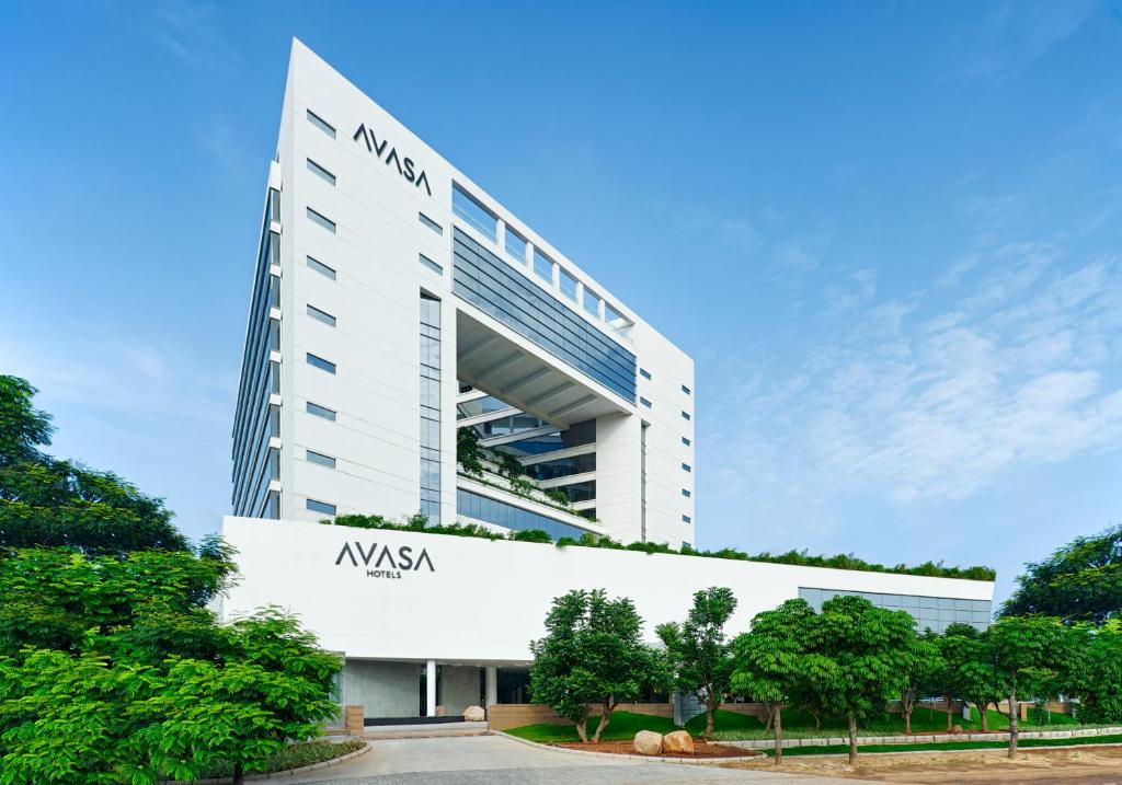 a large white building with a nissan sign on it at Avasa Hotel in Hyderabad