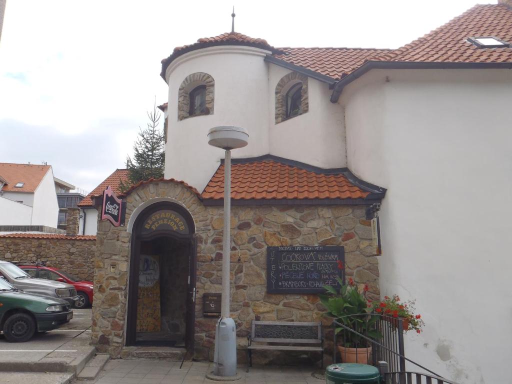 a building with a sign in front of it at Penzion na Zborově in Strakonice