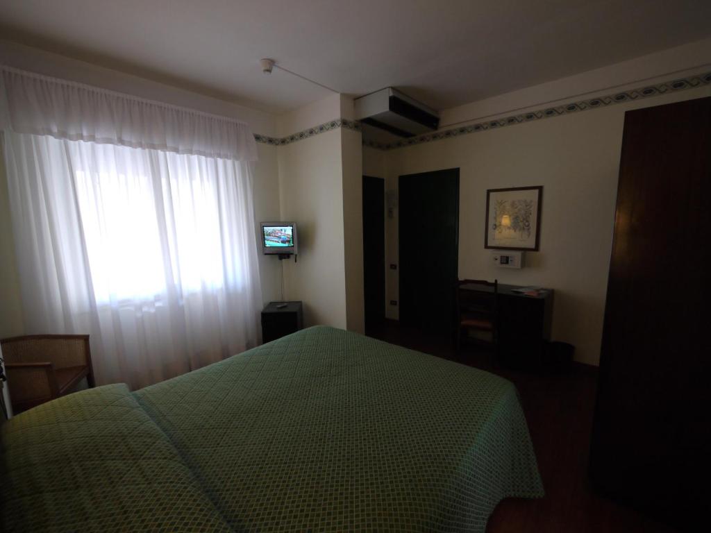 Postel nebo postele na pokoji v ubytování Hotel Piccadilly