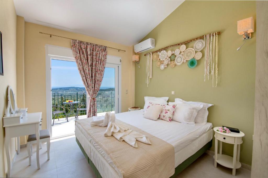 a bedroom with a bed and a large window at Villa Agnanti in Vlachopoulátika