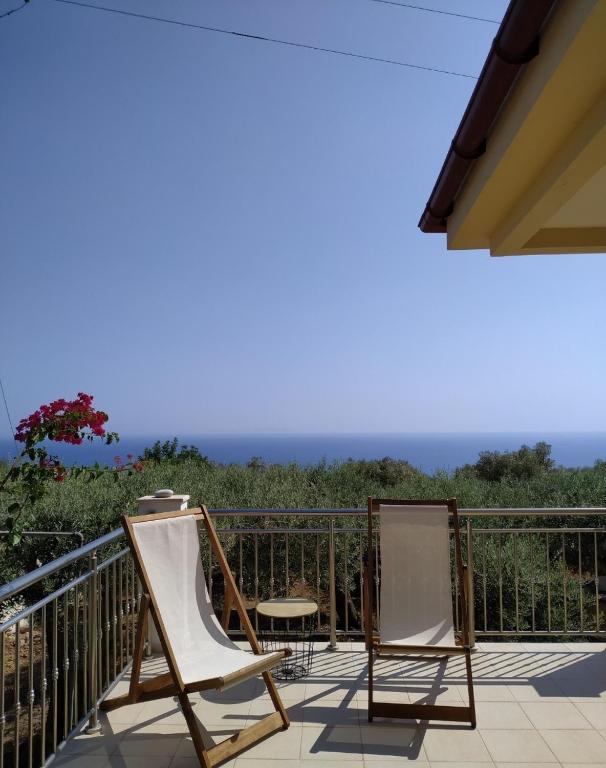 a patio with two chairs and a table on a balcony at Villa Elia in Sfakia