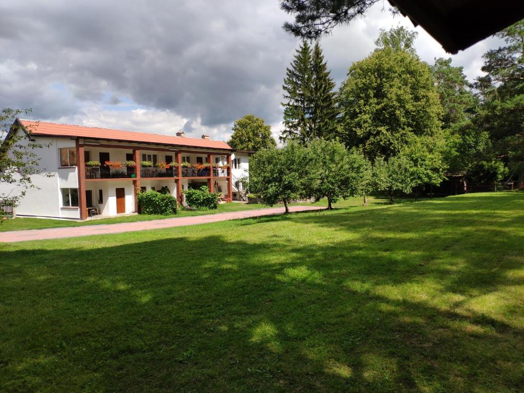 a building with a large lawn in front of it at Apartamenty wakacyjne nad jeziorem Juksty in Mrągowo