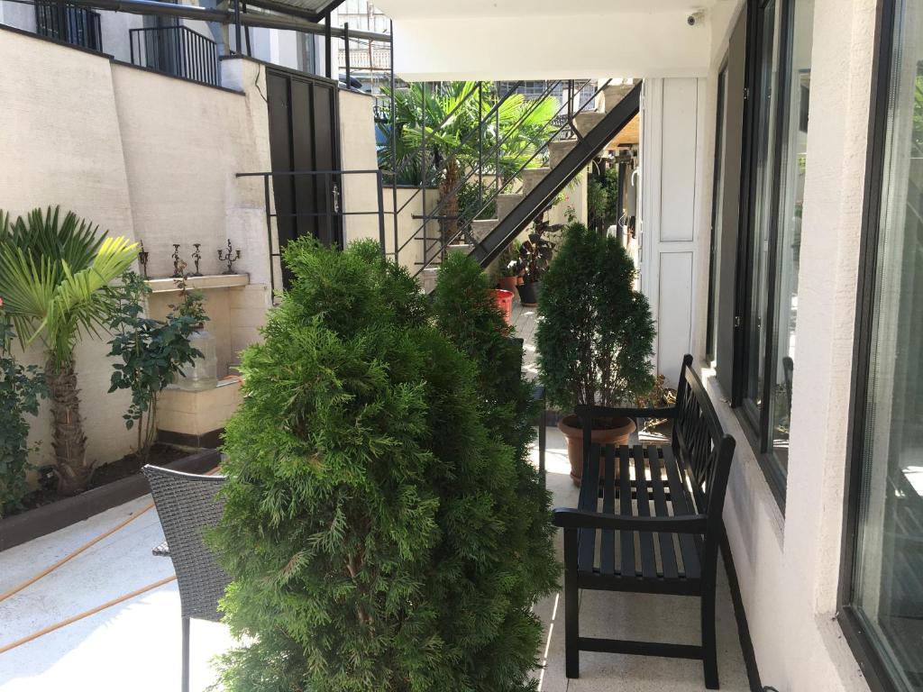 a balcony with a bunch of plants and benches at 10 shindisi street,Tbilisi in Tbilisi City