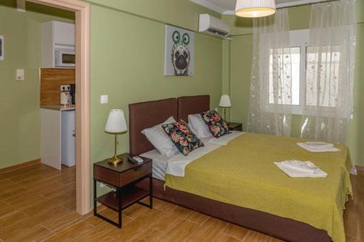 een slaapkamer met een groot bed en een gele deken bij YOUR ATTIKI HOME vipgreece in Athene