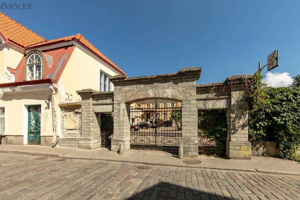 a building with a gate in front of a house at Perfect stay in Old Town with Parking in Tallinn