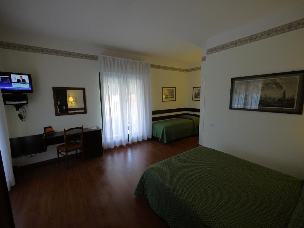 Postel nebo postele na pokoji v ubytování Hotel Piccadilly
