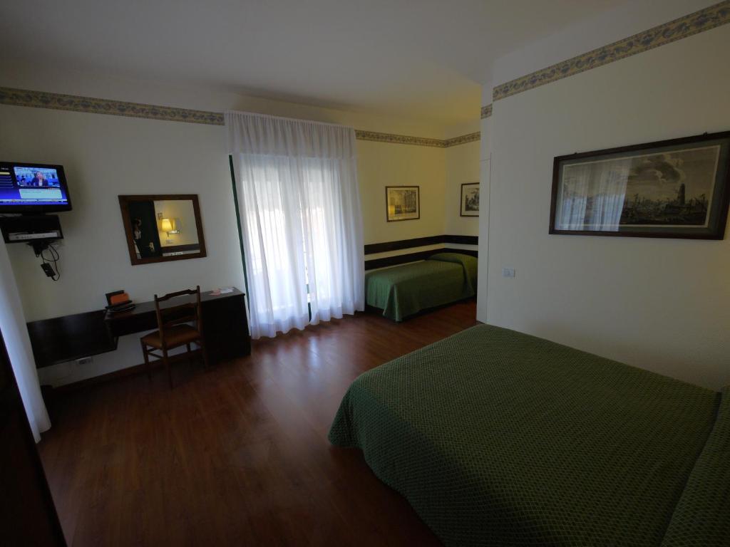 Postel nebo postele na pokoji v ubytování Hotel Piccadilly