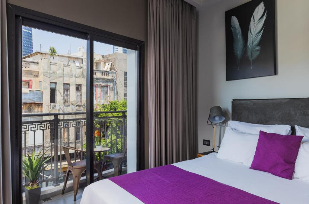 מיטה או מיטות בחדר ב-Kalvin Boutique Hotel by Levinsky Market Tel-Aviv