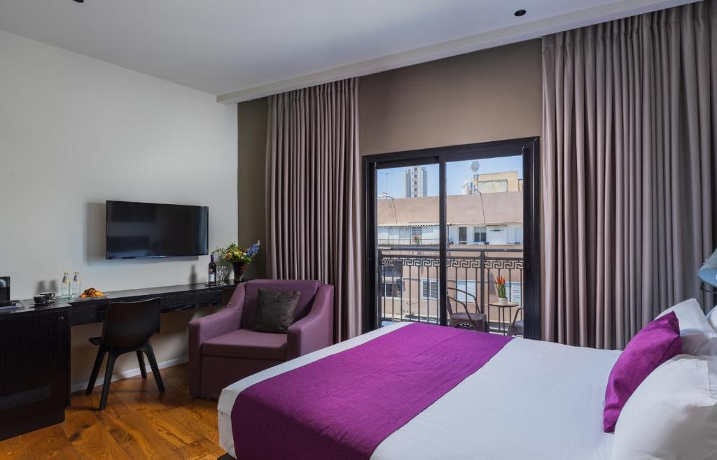 מיטה או מיטות בחדר ב-Kalvin Boutique Hotel by Levinsky Market Tel-Aviv