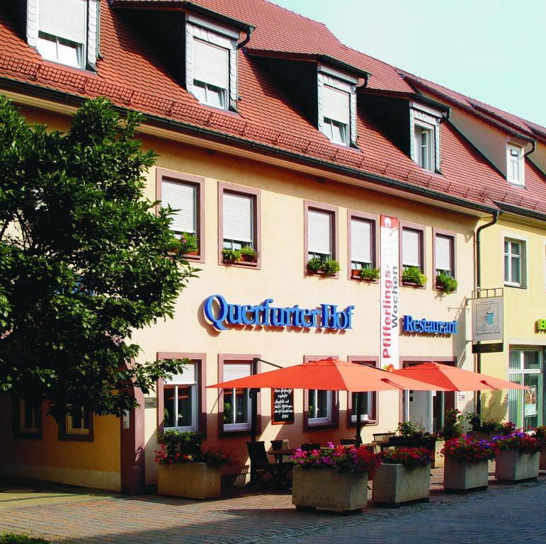 a building with orange umbrellas in front of it at Querfurter Hof in Querfurt