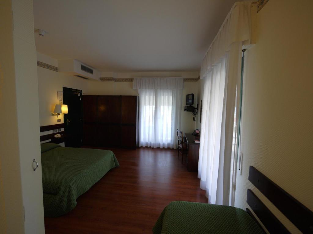 Postel nebo postele na pokoji v ubytování Hotel Piccadilly