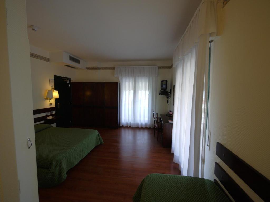 Postel nebo postele na pokoji v ubytování Hotel Piccadilly