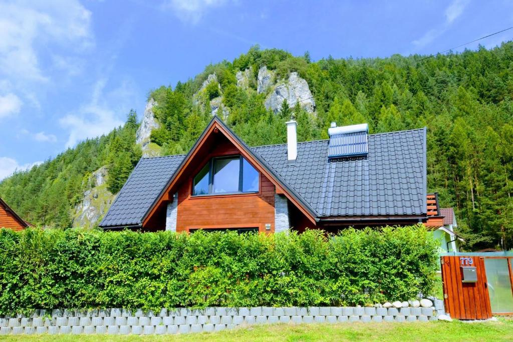 a house with a mountain in the background at STOP&RELAX Apartment in Liptovská Osada