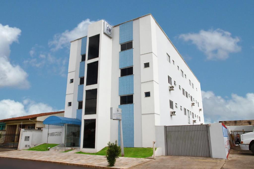 um edifício branco com muitas janelas em Monte Castro Executive Hotel em Araguari