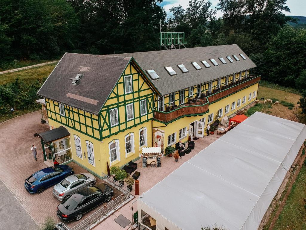 an overhead view of a house with cars parked in front at Hotel Restaurant 7 Berge am Schlehberg in Alfeld