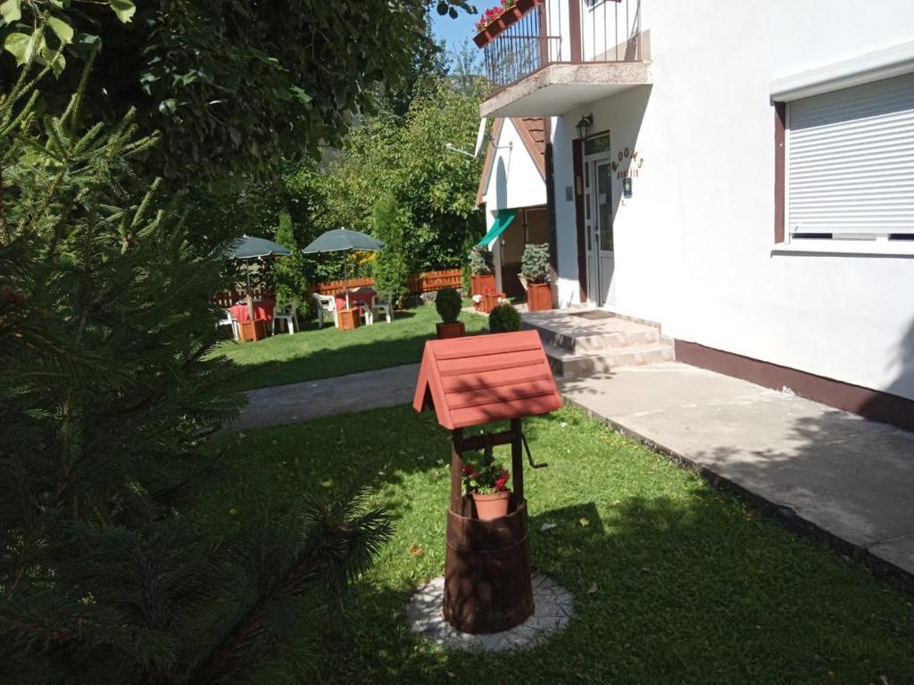 a bird feeder in the yard of a house at Rooms Lisičić in Kolašin